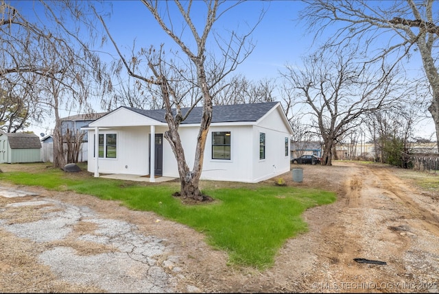 view of front facade with a storage shed