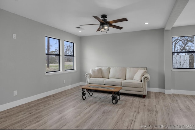 living room featuring ceiling fan and light hardwood / wood-style floors