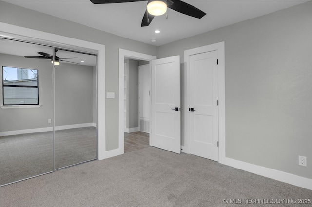 unfurnished bedroom with ceiling fan and light colored carpet