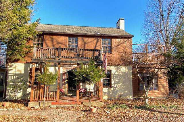 rear view of house featuring a balcony