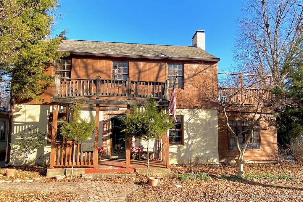 rear view of property featuring a balcony