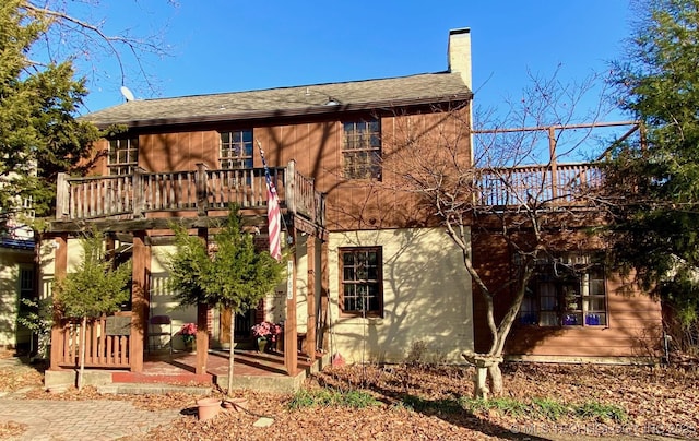 back of property featuring a patio area and a chimney