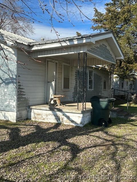 rear view of property featuring a lawn