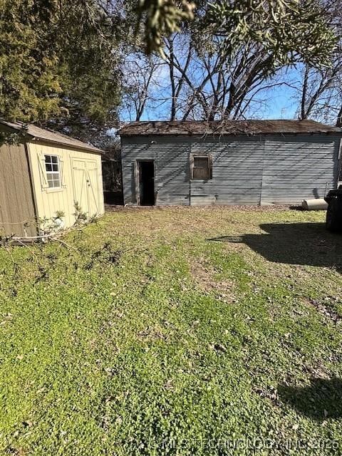 view of outbuilding featuring a lawn