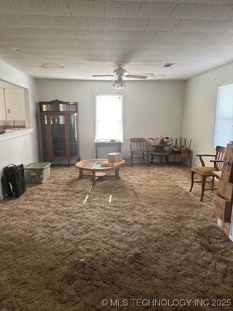 interior space featuring carpet and ceiling fan