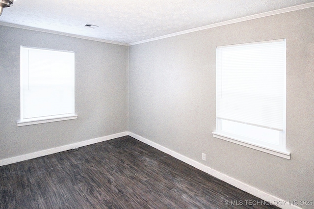 spare room with a textured ceiling, crown molding, and dark hardwood / wood-style flooring