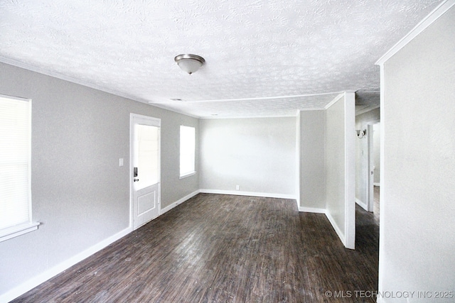 unfurnished room with a textured ceiling and dark hardwood / wood-style floors