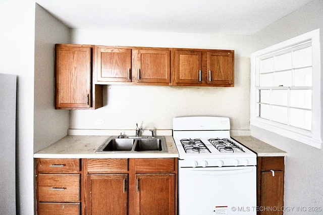 kitchen featuring sink and white gas stove