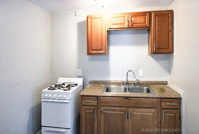 kitchen with sink and white gas stove