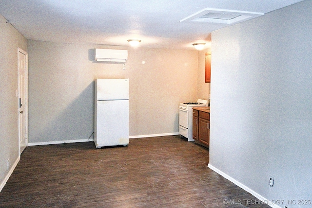 kitchen with white appliances, a wall mounted air conditioner, and dark wood-type flooring