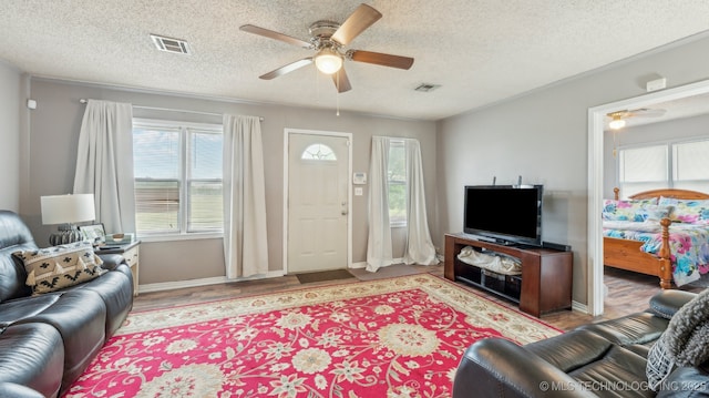 2019 Mckenzie Rd, Pawhuska, OK 74056 - living area with a ceiling fan, a textured ceiling, baseboards, and light wood-type flooring