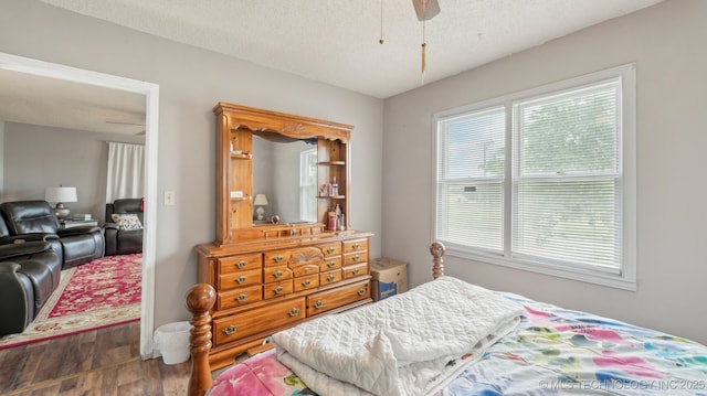 2019 Mckenzie Rd, Pawhuska, OK 74056 - bedroom featuring wood finished floors and a textured ceiling
