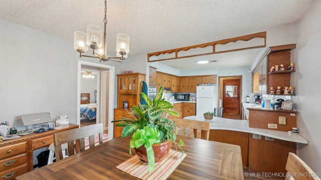 2019 Mckenzie Rd, Pawhuska, OK 74056 - dining space featuring a textured ceiling, a chandelier, and a desk