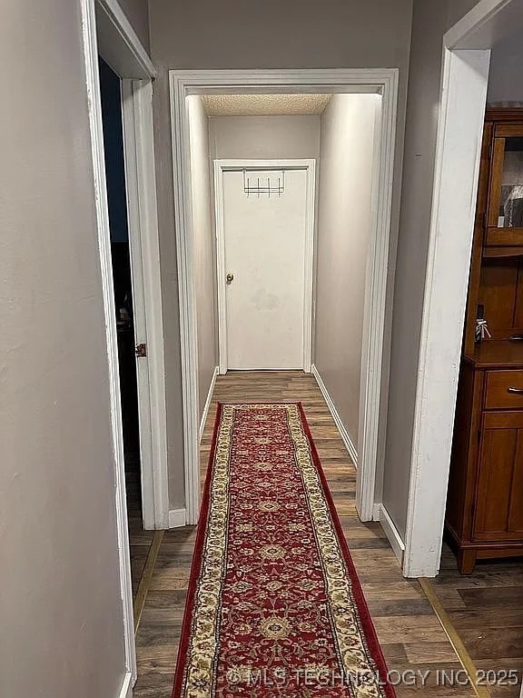 corridor featuring dark wood-type flooring