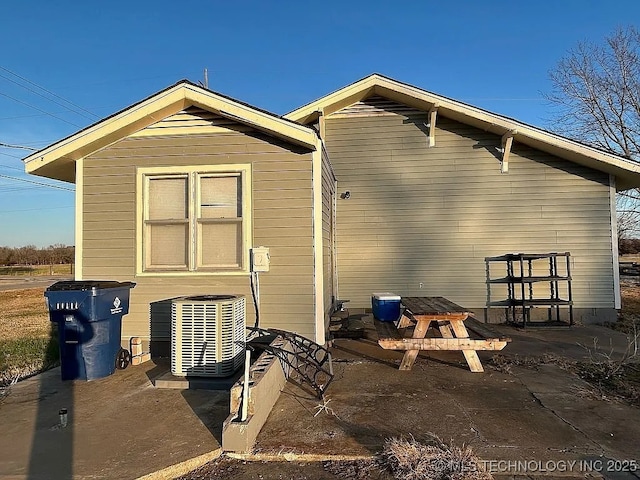 back of house with central AC unit