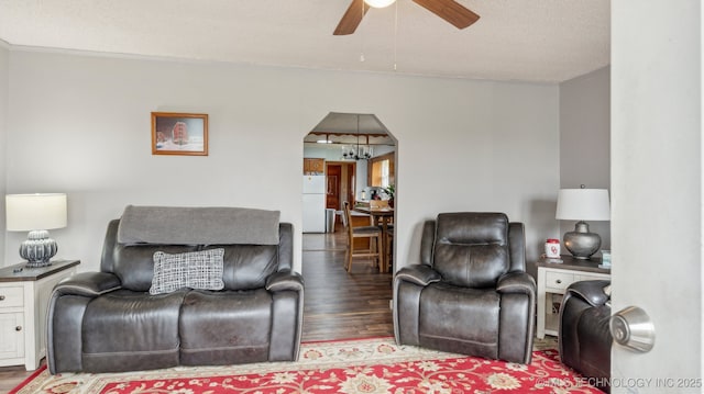 2019 Mckenzie Rd, Pawhuska, OK 74056 - living room with ceiling fan, wood finished floors, arched walkways, a chandelier, and ornamental molding