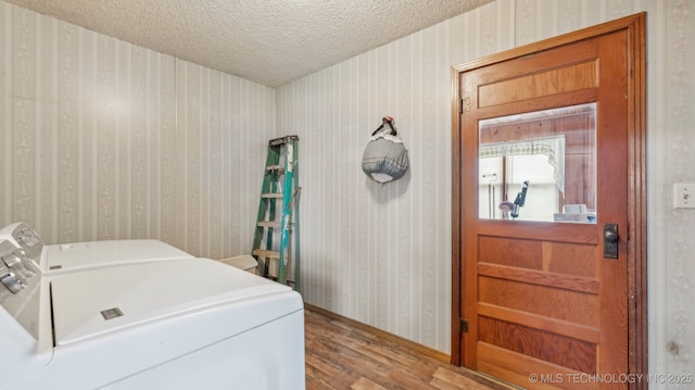 2019 Mckenzie Rd, Pawhuska, OK 74056 - laundry area with washing machine and dryer, wood finished floors, baseboards, a textured ceiling, and wallpapered walls