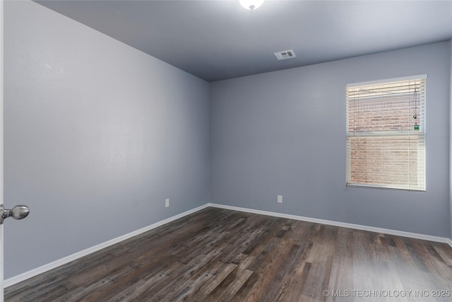 unfurnished room with dark hardwood / wood-style flooring