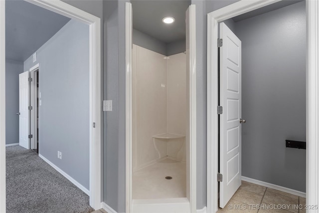 bathroom featuring a shower and tile patterned flooring