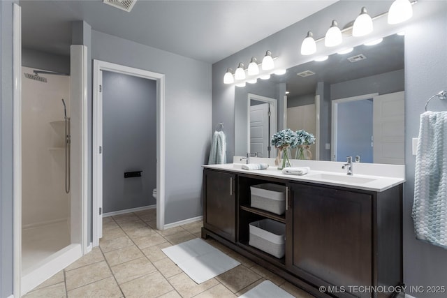 bathroom featuring vanity, tile patterned flooring, a shower, and toilet