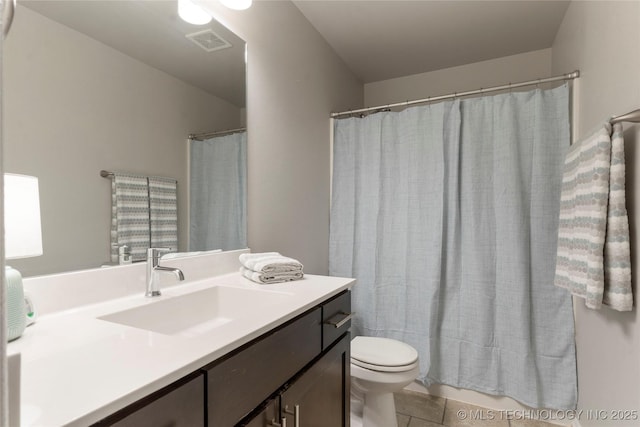 bathroom with a shower with shower curtain, tile patterned floors, vanity, and toilet