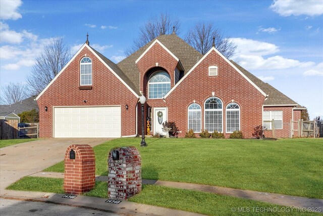 view of front of house featuring a garage and a front lawn