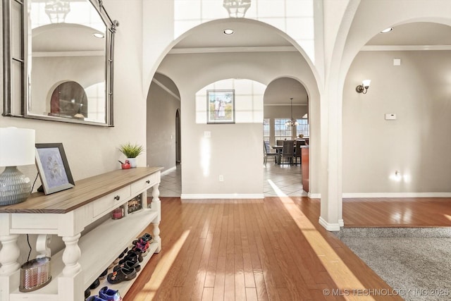 hall with ornamental molding and hardwood / wood-style flooring