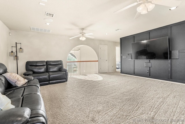 living room with ceiling fan and carpet flooring