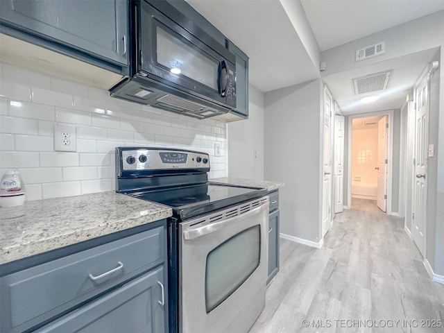 kitchen featuring stainless steel electric range, light hardwood / wood-style flooring, and decorative backsplash