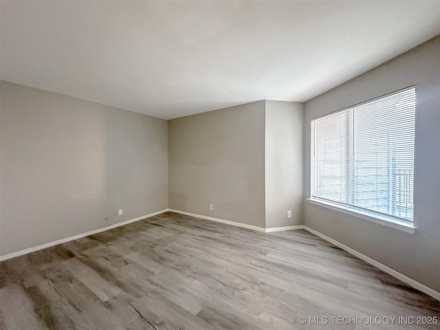 spare room featuring light hardwood / wood-style flooring