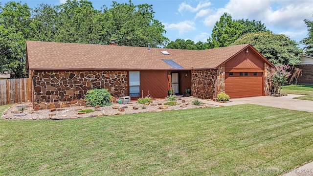 ranch-style home featuring a garage and a front lawn