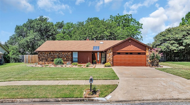 ranch-style house featuring a garage and a front yard