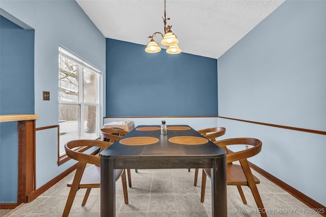 dining area with a textured ceiling, lofted ceiling, and a notable chandelier