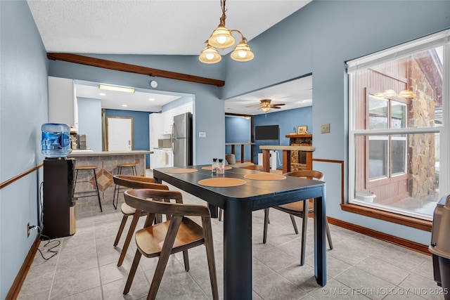 dining room with ceiling fan, light tile patterned flooring, and lofted ceiling