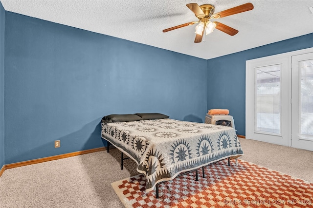 bedroom featuring ceiling fan, carpet flooring, and a textured ceiling