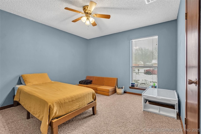 bedroom featuring ceiling fan, carpet, and a textured ceiling