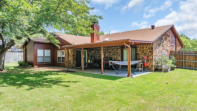 back of property featuring a yard and a patio