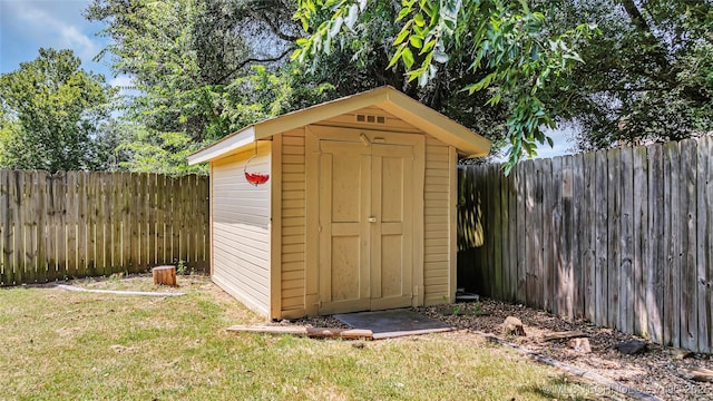 view of outdoor structure featuring a lawn