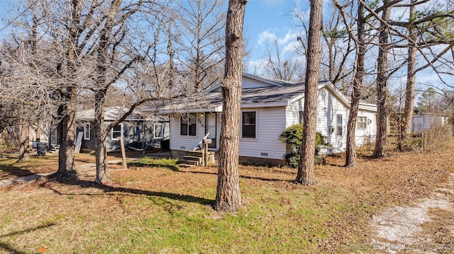 rear view of house featuring a lawn