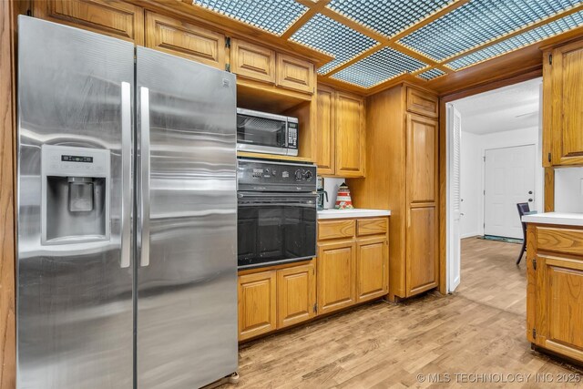 kitchen with appliances with stainless steel finishes and light wood-type flooring