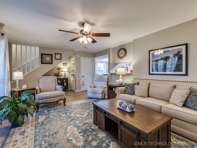 living room featuring ceiling fan and light hardwood / wood-style floors