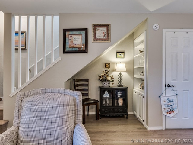 living area with light hardwood / wood-style floors and built in features