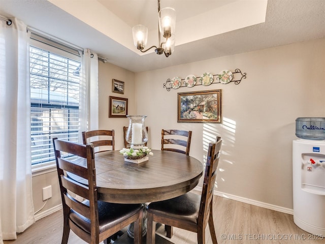 dining room with a chandelier and light wood-type flooring