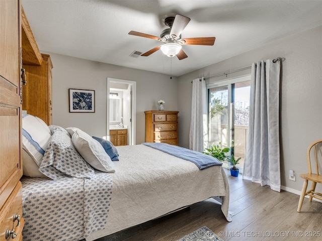 bedroom featuring ceiling fan, light wood-type flooring, and ensuite bath