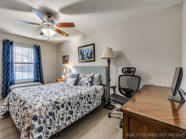 bedroom with hardwood / wood-style floors and ceiling fan