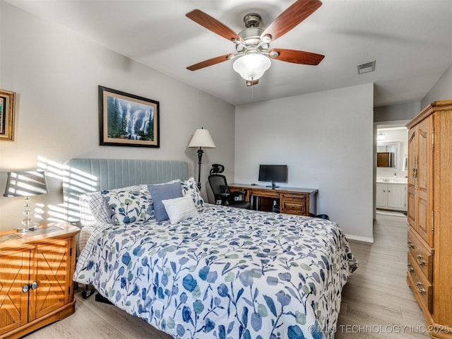 bedroom featuring connected bathroom, ceiling fan, and light wood-type flooring