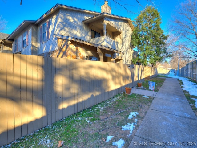 view of side of property with a balcony