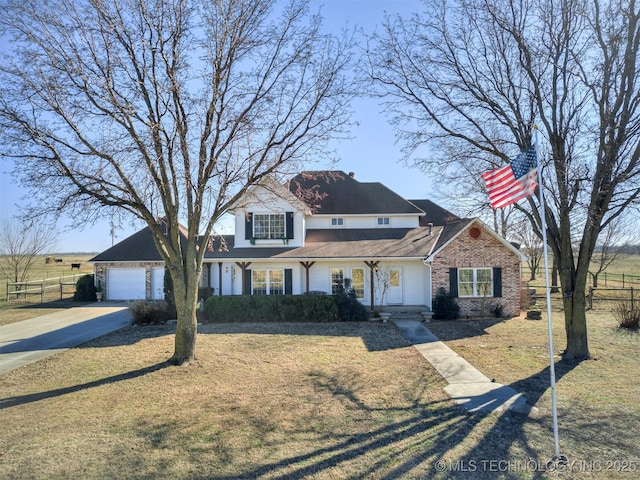 view of front facade with a garage and a front lawn