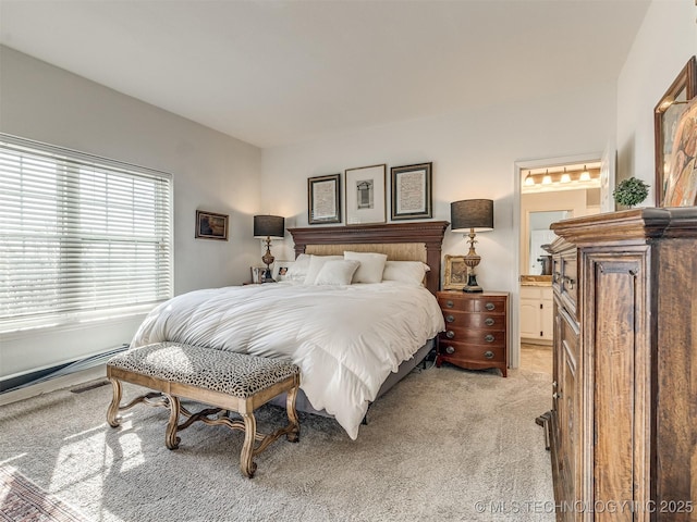 carpeted bedroom featuring ensuite bathroom