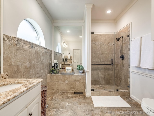 bathroom with crown molding, toilet, an enclosed shower, and vanity